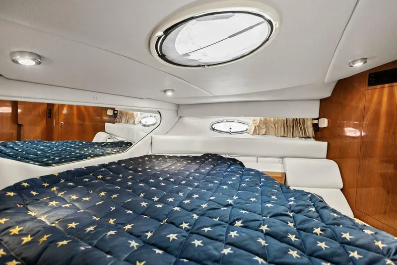 Slide: The Image of Luxurious cabin interior of 2005 Regal Commodore 3560 yacht with star-patterned bedding. - 30
