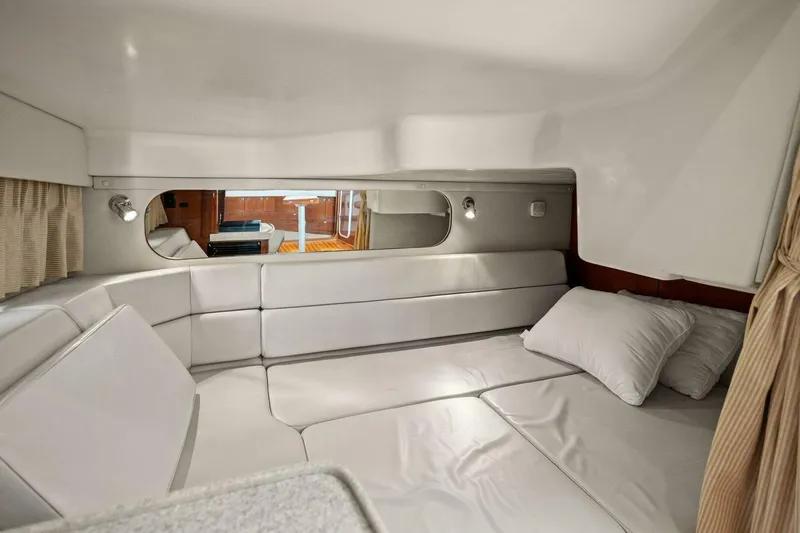 Slide: The Image of 2005 Regal Commodore 3560 interior cabin with white leather seating and pillows. - 32