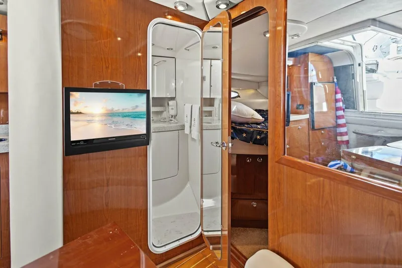 Slide: The Image of Luxurious interior of 2005 Regal Commodore 3560 yacht with wood finishes and modern amenities. - 33