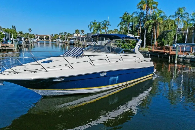 Slide: The Image of 2005 Regal Commodore 3560 yacht docked in a scenic canal with palm trees. - 5