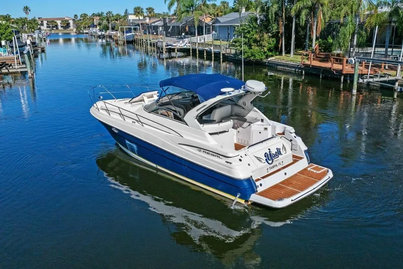 Slide: The Image of 2005 Regal Commodore 3560 yacht cruising in a scenic canal with palm trees. - 8