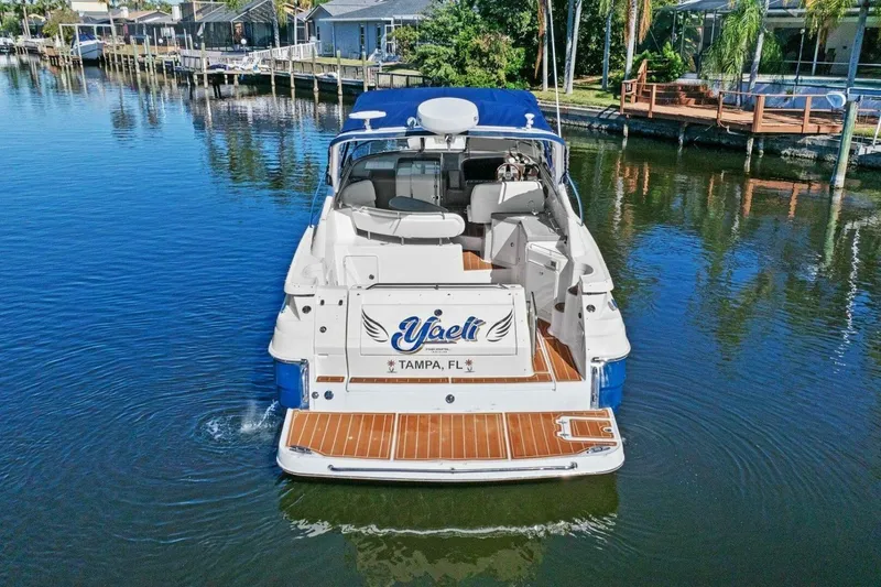 Slide: The Image of 2005 Regal Commodore 3560 yacht docked in a serene waterfront setting. - 9