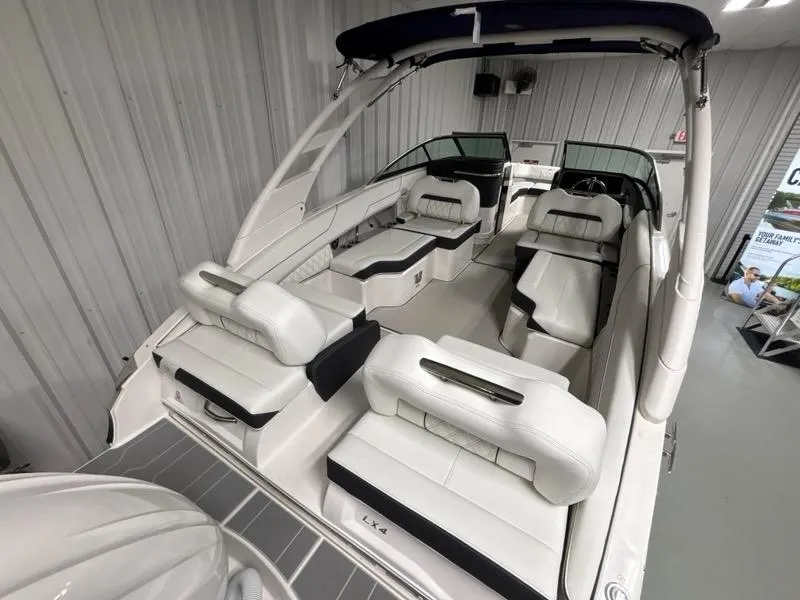 Slide: The Image of 2026 Regal LX4 boat interior with white leather seating in a showroom. - 7