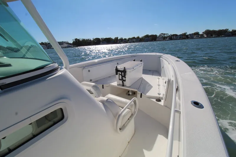 Slide: The Image of 2009 Everglades 320 Center Console boat cruising on sunny waters. - 10