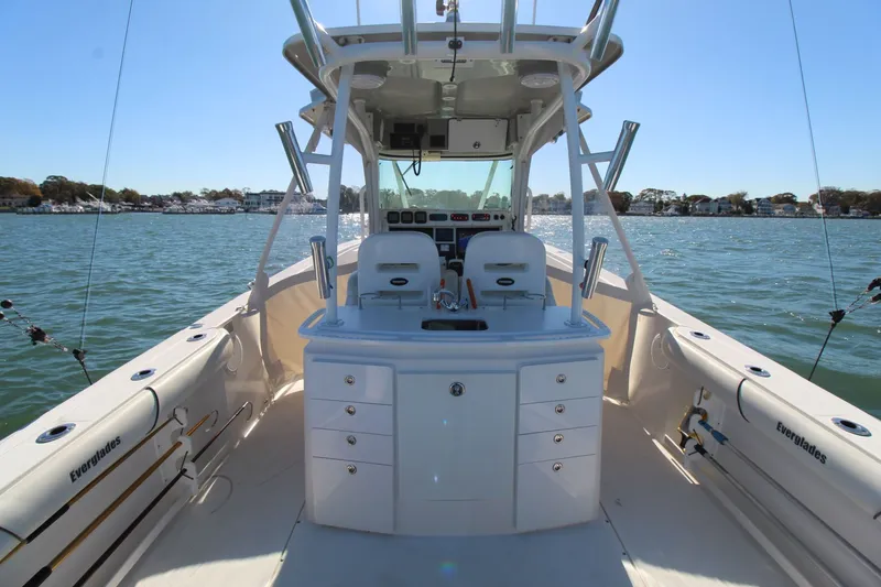 Slide: The Image of 2009 Everglades 320 Center Console boat on water, featuring spacious deck and fishing equipment. - 11