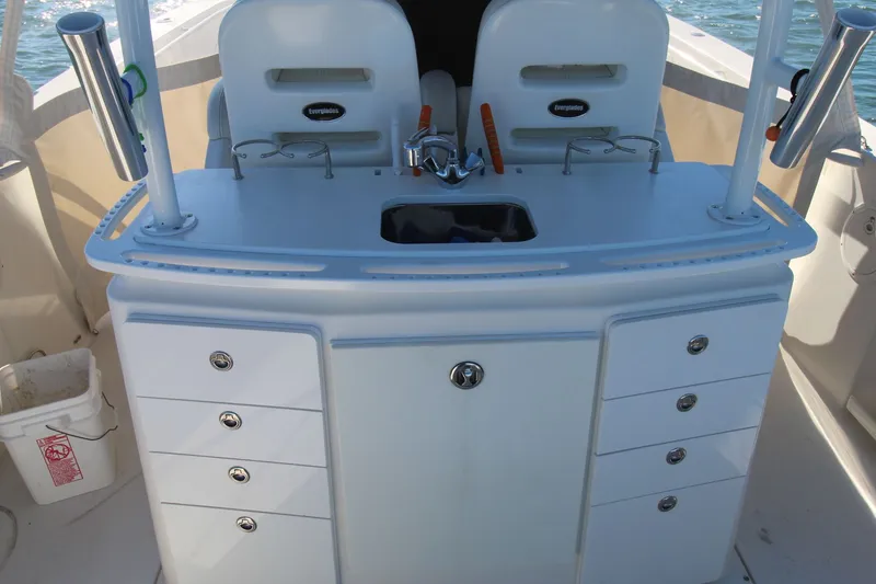 Slide: The Image of 2009 Everglades 320 Center Console boat interior with storage and sink. - 12