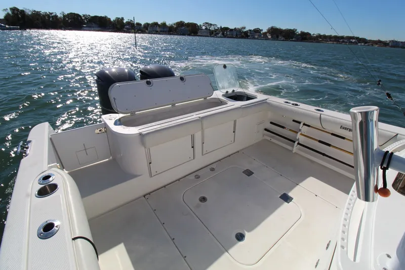 Slide: The Image of 2009 Everglades 320 Center Console boat on water, featuring spacious deck and dual engines. - 13