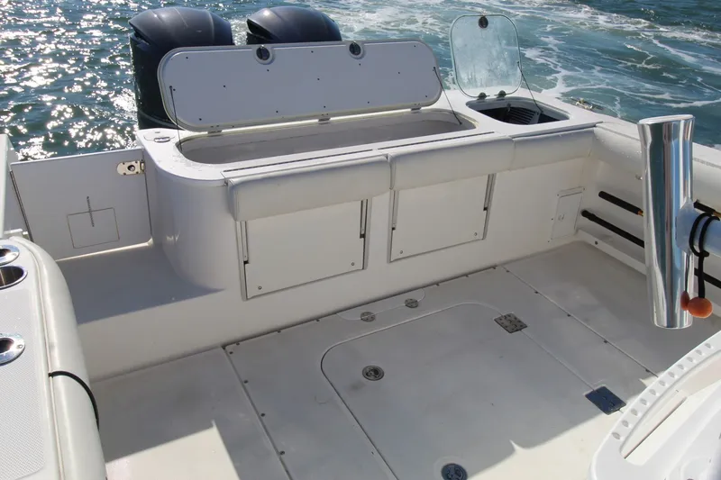 Slide: The Image of 2009 Everglades 320 Center Console boat deck with storage compartments and twin engines. - 14