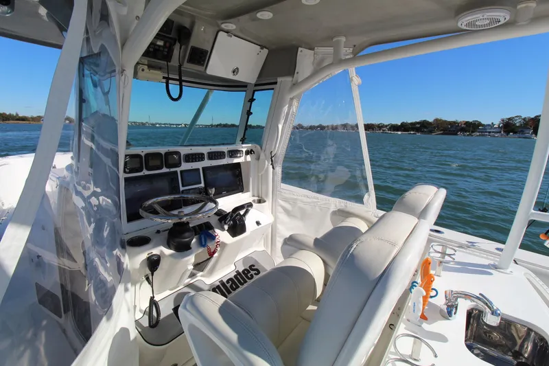 Slide: The Image of 2009 Everglades 320 Center Console boat interior with steering wheel and navigation equipment. - 18