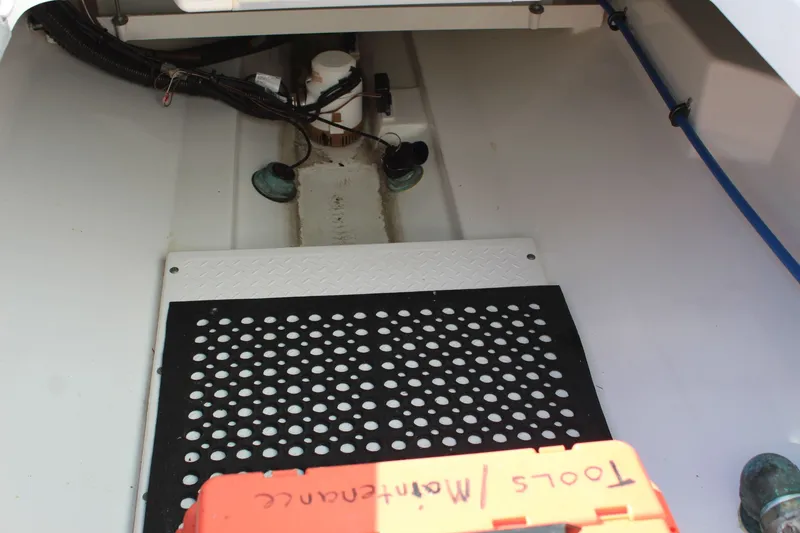 Slide: The Image of 2009 Everglades 320 Center Console interior with maintenance tools and wiring. - 20