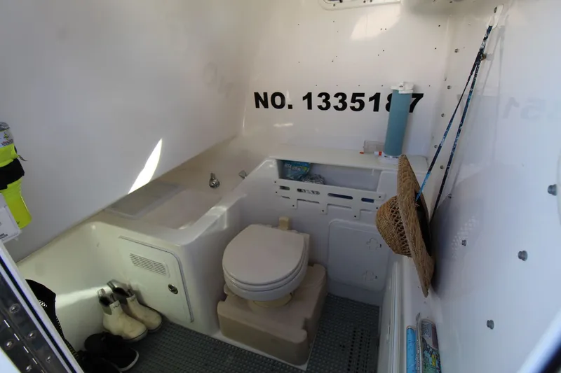 Slide: The Image of Interior of 2009 Everglades 320 Center Console boat with toilet and storage. - 21