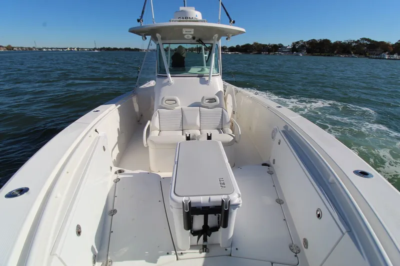 Slide: The Image of 2009 Everglades 320 Center Console boat on water, featuring spacious deck and seating. - 7