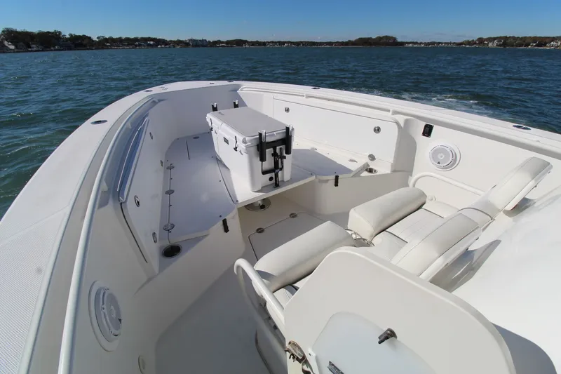 Slide: The Image of 2009 Everglades 320 Center Console boat on water, featuring spacious seating and storage. - 9