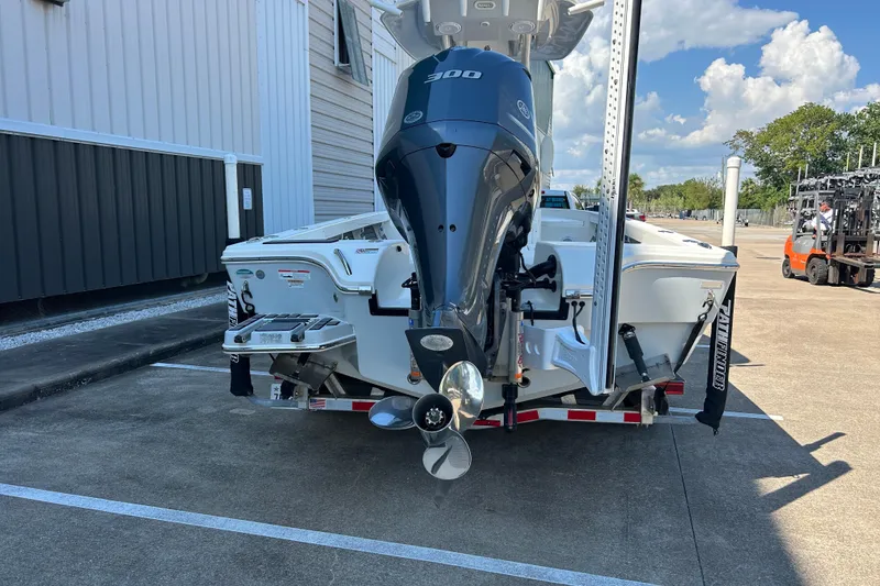 Slide: The Image of 2019 Pathfinder 2600 HPS boat with powerful outboard motor in a parking lot. - 13