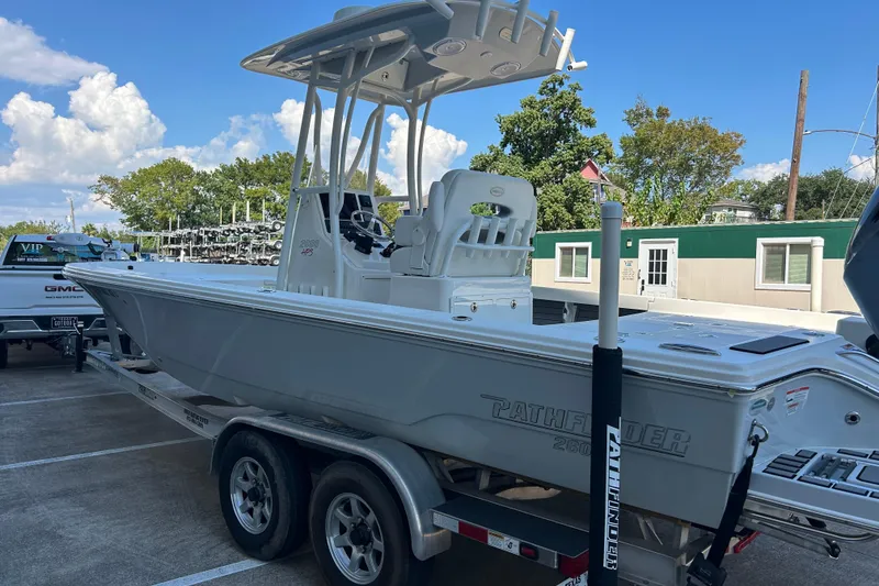 Slide: The Image of 2019 Pathfinder 2600 HPS boat on trailer in parking lot, clear sky background. - 17