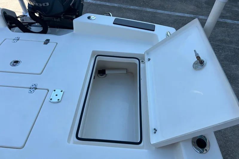 Slide: The Image of 2019 Pathfinder 2600 HPS boat storage compartment with open lid and visible engine. - 21