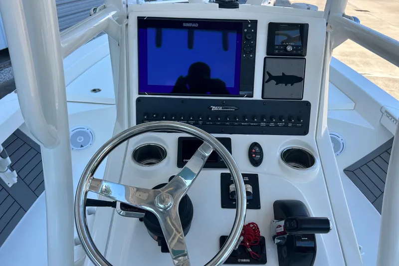 Slide: The Image of 2019 Pathfinder 2600 HPS boat console with steering wheel and navigation controls. - 22