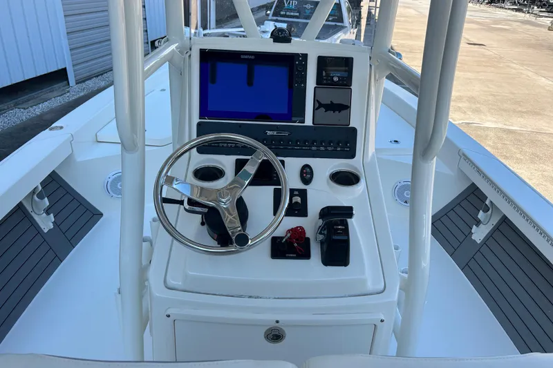 Slide: The Image of 2019 Pathfinder 2600 HPS boat console with steering wheel and navigation system. - 23