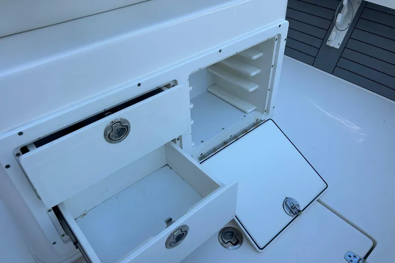 Slide: The Image of 2019 Pathfinder 2600 HPS boat storage compartments with open drawers and hatches. - 24