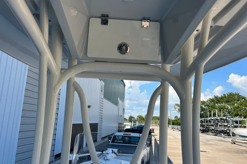 Slide: The Image of 2019 Pathfinder 2600 HPS boat T-top structure with storage compartment, outdoor setting. - 27