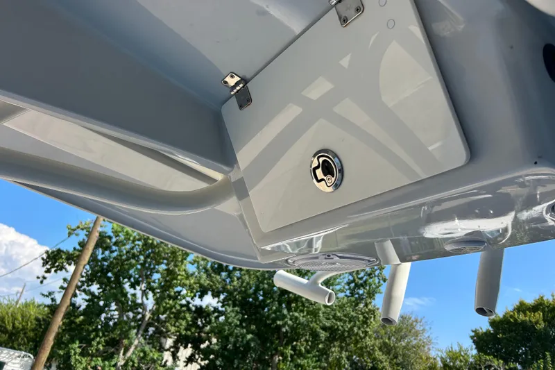 Slide: The Image of 2019 Pathfinder 2600 HPS boat detail, featuring a hatch and rod holders under a clear sky. - 29