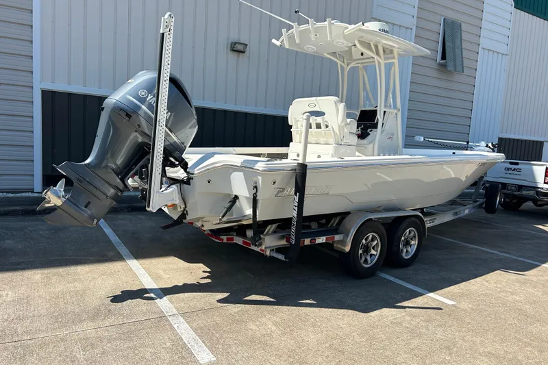 Slide: The Image of 2019 Pathfinder 2600 HPS boat on trailer, parked outdoors near a building. - 3