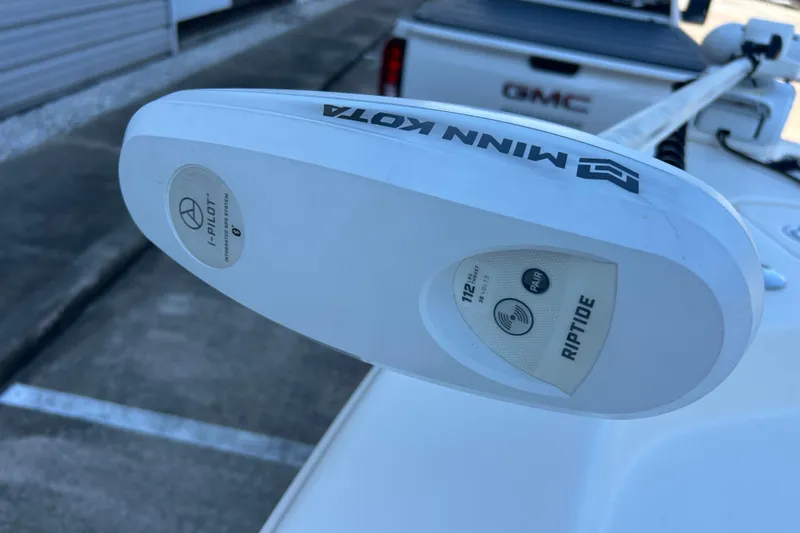 Slide: The Image of Minn Kota Riptide trolling motor on 2019 Pathfinder 2600 HPS boat, parked near GMC truck. - 32