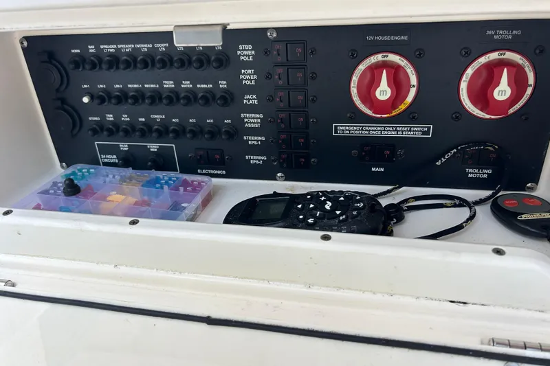 Slide: The Image of Control panel of a 2019 Pathfinder 2600 HPS boat with switches and electronics. - 34