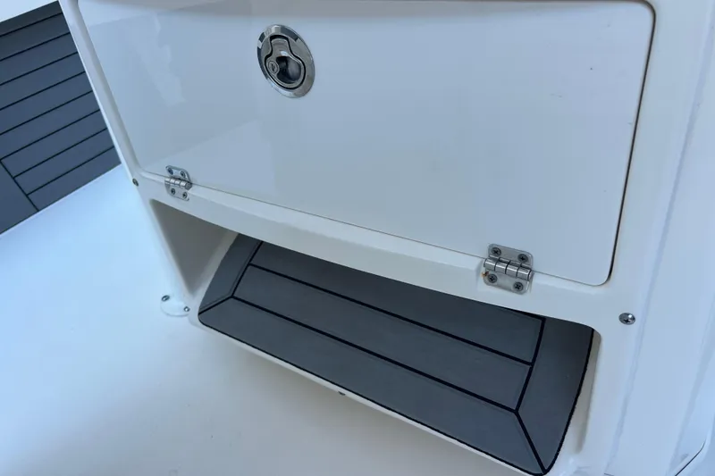 Slide: The Image of 2019 Pathfinder 2600 HPS boat storage compartment with secure latch and cushioned interior. - 35