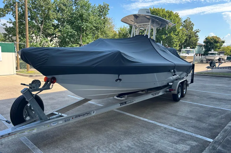 Slide: The Image of 2019 Pathfinder 2600 HPS boat covered on trailer in parking lot. - 6