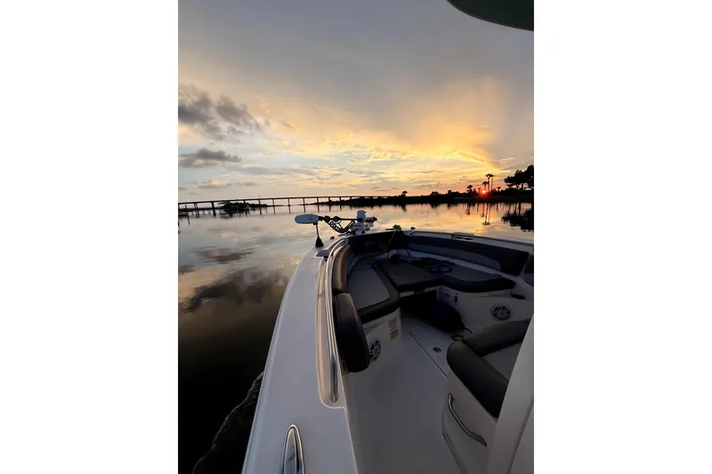 Slide: The Image of 2023 NauticStar 2602 Legacy boat at sunset on calm waters. - 12