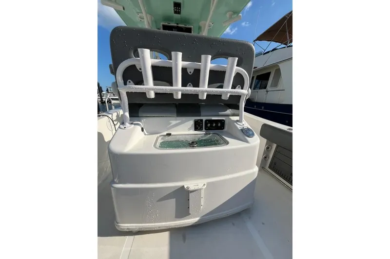 Slide: The Image of 2023 NauticStar 2602 Legacy boat interior with rod holders and storage compartment. - 9
