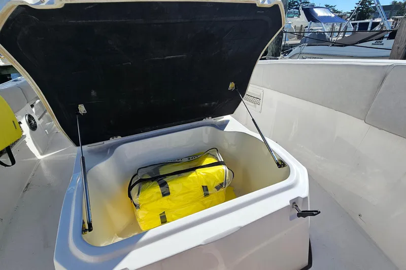 Slide: The Image of Open storage compartment on 2024 Sea Fox 268 Commander boat with yellow bag inside. - 10