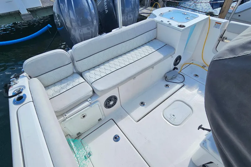 Slide: The Image of 2024 Sea Fox 268 Commander boat interior with cushioned seating and dual outboard motors. - 12