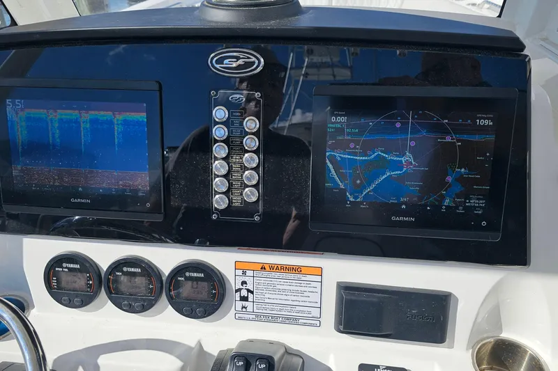 Slide: The Image of 2024 Sea Fox 268 Commander dashboard with Garmin navigation displays and Yamaha gauges. - 16