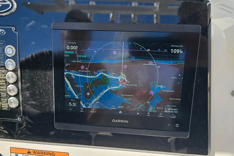 Slide: The Image of 2024 Sea Fox 268 Commander with Garmin navigation display showing nautical map and GPS data. - 17