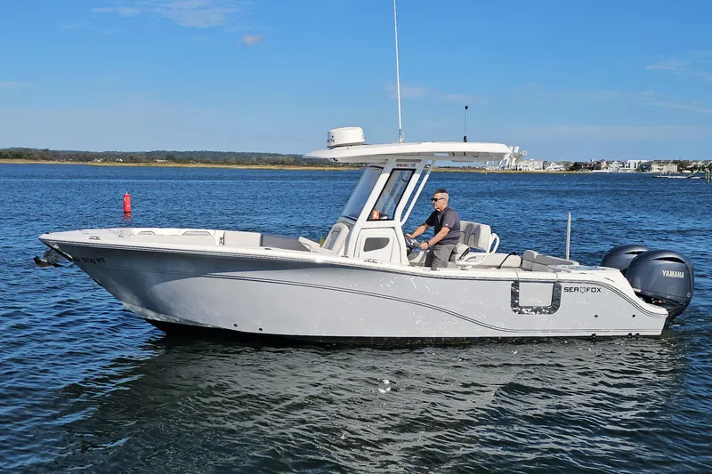 Slide: The Image of 2024 Sea Fox 268 Commander boat cruising on a sunny day with a clear blue sky. - 4