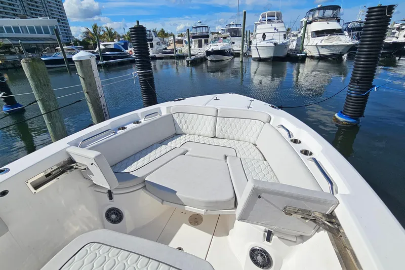 Slide: The Image of 2024 Sea Fox 268 Commander boat interior with cushioned seating at marina. - 6