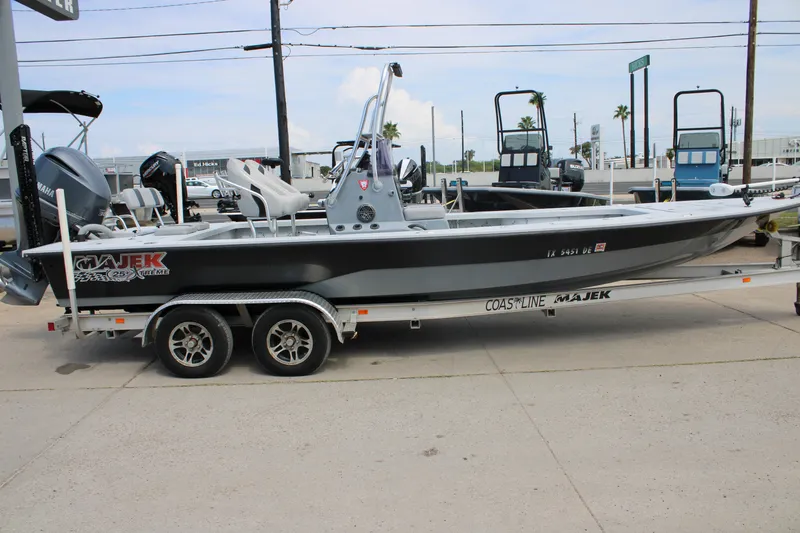 Slide: The Image of 2014 Majek Xtreme 25 boat on trailer, parked outdoors. - 14