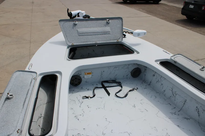 Slide: The Image of 2014 Majek Xtreme 25 boat deck with open storage compartments and trolling motor. - 20