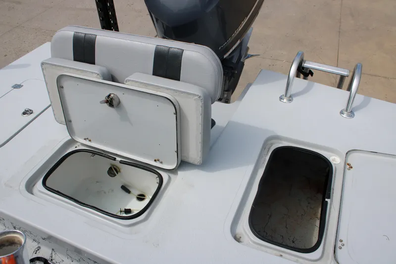 Slide: The Image of 2014 Majek Xtreme 25 boat deck with open storage compartments and seating. - 4