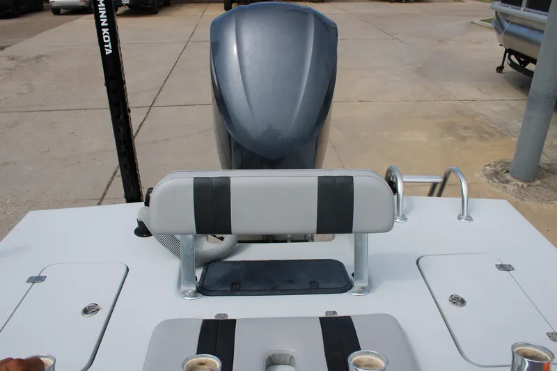 Slide: The Image of 2014 Majek Xtreme 25 boat with seating and motor, parked on concrete. - 5