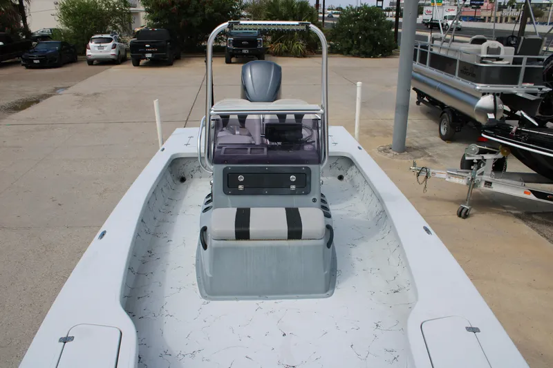 Slide: The Image of 2014 Majek Xtreme 25 boat with center console and seating, parked on concrete. - 7