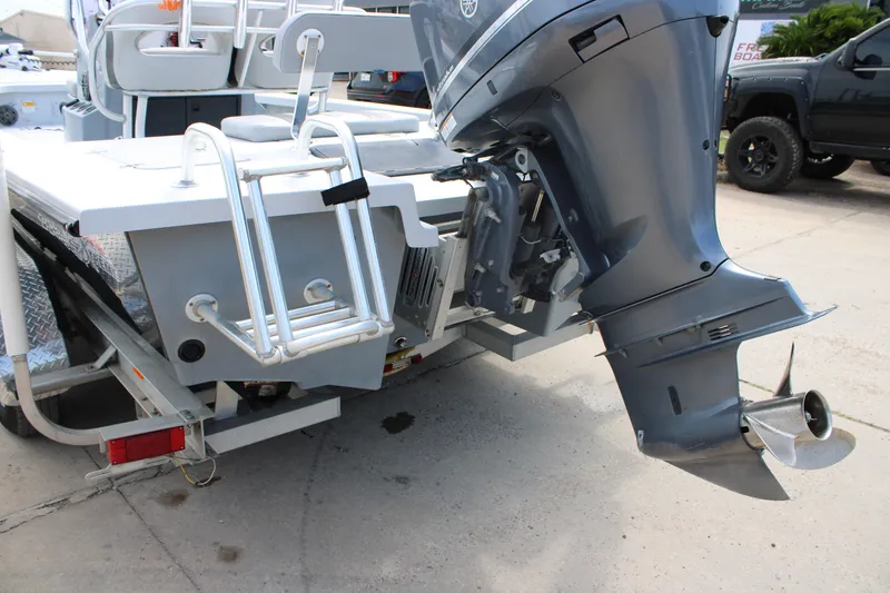 Slide: The Image of 2014 Majek Xtreme 25 boat with outboard motor and ladder, parked on a trailer. - 9