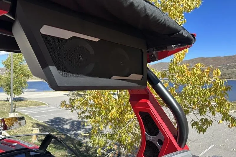 Slide: The Image of 2024 Supra SE 575 boat speaker system with scenic lake and mountain background. - 7