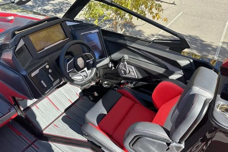 Slide: The Image of 2024 Supra SE 575 boat interior with modern dashboard and red-black seating. - 8