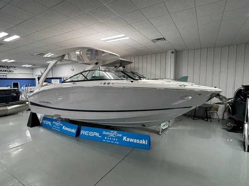 Slide: The Image of 2026 Regal LX6 boat displayed indoors at a showroom, featuring sleek design and modern amenities. - 11