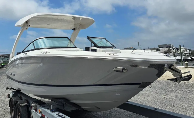 Slide: The Image of 2026 Regal LX6 boat on trailer under blue sky. - 13