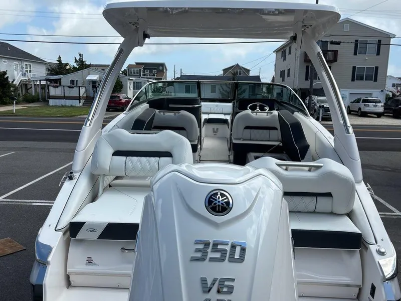 Slide: The Image of 2026 Regal LX6 boat with Yamaha 350 V6 engine, parked in a residential area. - 14