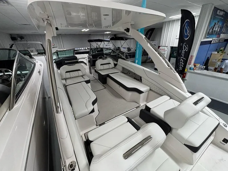 Slide: The Image of 2026 Regal LX6 boat interior with luxurious white seating and modern design in showroom. - 28